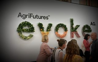 Conference attendees walking past the welcome sign in the entrance hall at evokeAG 2020.