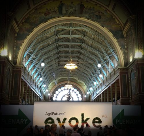 AgriFutures evokeAG sign in the entrance hall of the heritage-listed Royal Exhibition Building in Melbourne, looking up at the vaulted ceiling.